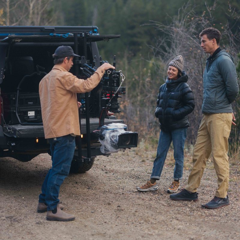 Crew setting up a camera rig on a truck tailgate during an automotive shoot
