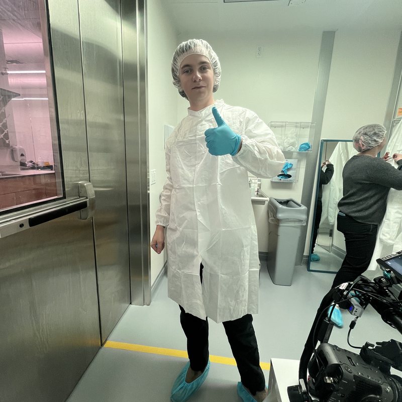 Crew member gowned up in a cleanroom during a healthcare shoot