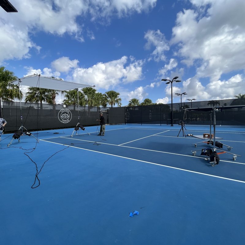 Lighting and camera setup on a tennis court